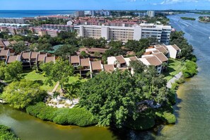 A resort with multiple buildings, a river, and a marina.
