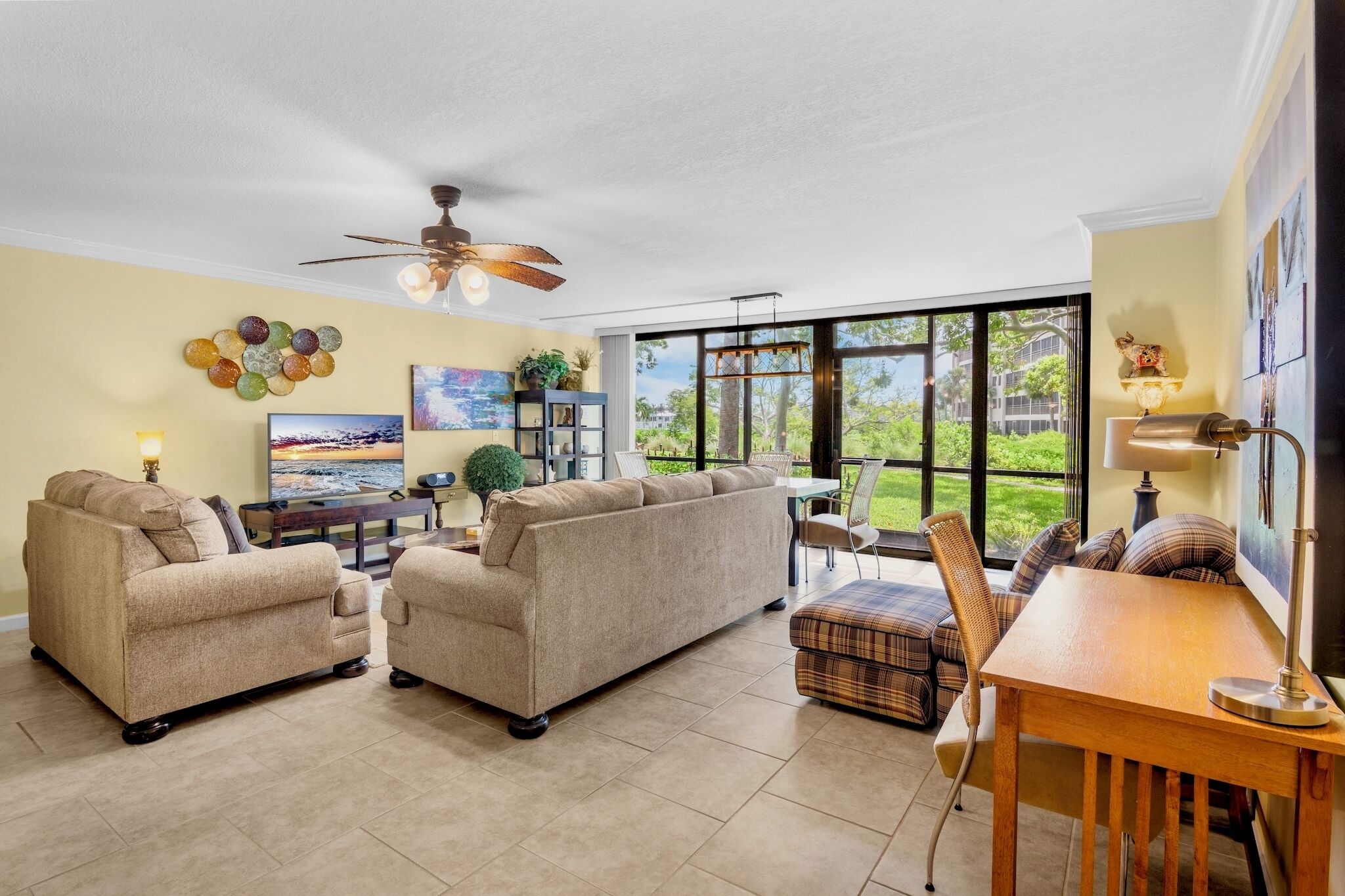 A spacious living room with a sofa set, a dining table, and a TV.