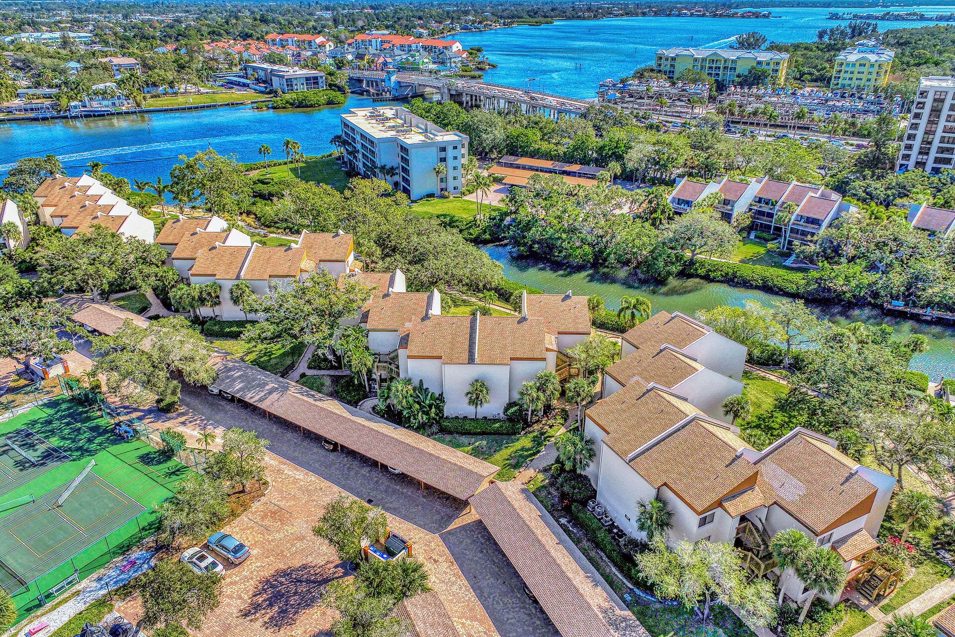 A coastal resort with villas, a marina, and a tennis court.