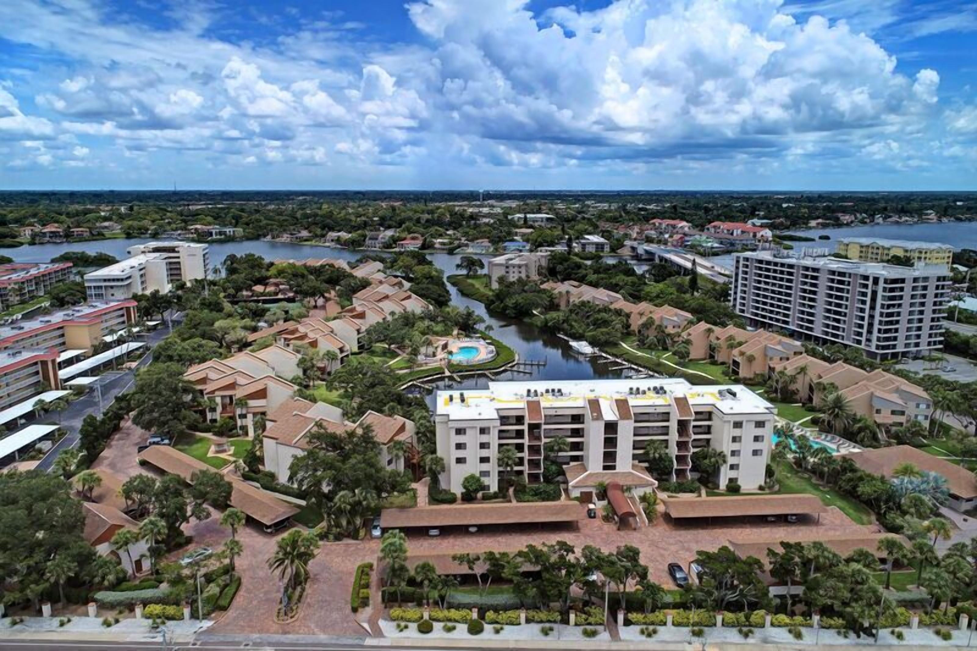 A hotel complex with multiple buildings, a central courtyard, and a river.