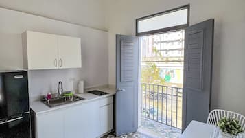 Classic Apartment | Private kitchenette | Fridge, stovetop, cookware/dishes/utensils, cleaning supplies