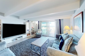 Relax in this stylish room with a large flat-screen TV, comfortable sofa, and balcony offering a sea view.