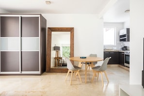 Una cucina moderna con zona pranzo, un armadio capiente e vista sull'esterno.