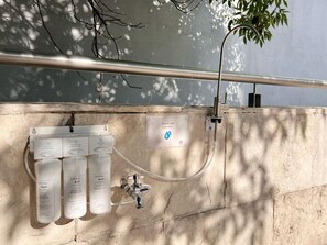 A water filtration system with three bottles labeled 'bebbia' and a water filter sign.