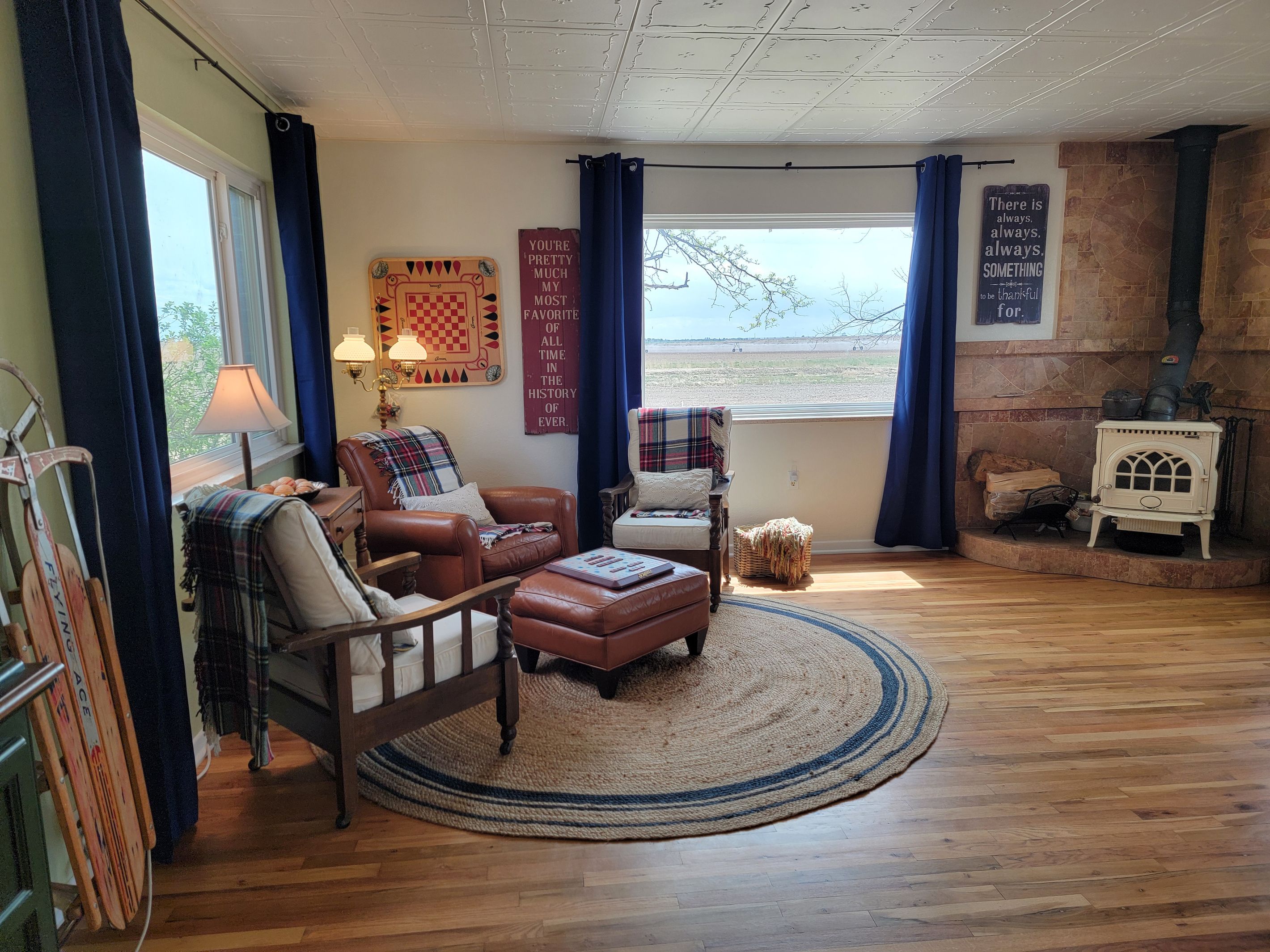A cozy living room with a fireplace, a comfortable sofa, and a view of the outdoors.
