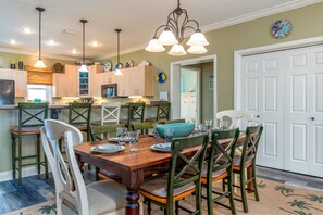 Enjoy meals in this dining area with a table for four, surrounded by comfortable chairs.