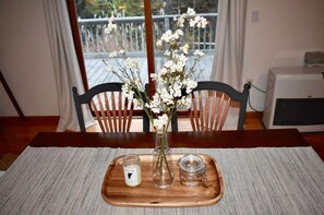 Enjoy meals for two in this inviting dining area with a view of the outdoor balcony.