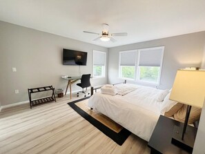 A bedroom with a bed, a desk, a chair, a TV, and windows. - Escape to Serenity: 18-Acre Catskill Retreat (Margaretville)