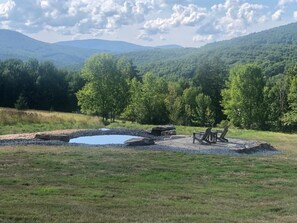 A natural landscape with a pond, seating area, and trees. - Escape to Serenity: 18-Acre Catskill Retreat (Margaretville)