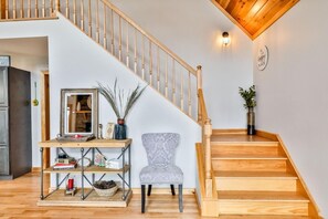 A staircase with wooden steps and a wooden railing, leading to an upper floor.