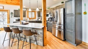 A modern kitchen with a central island, stainless steel appliances, and a wooden ceiling. - Lakeside Catskills Escape • Soak, Sip & Stargaze (Cairo)