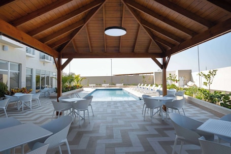 Outdoor pool, open 10:00 AM to 6:00 PM, pool umbrellas, sun loungers
