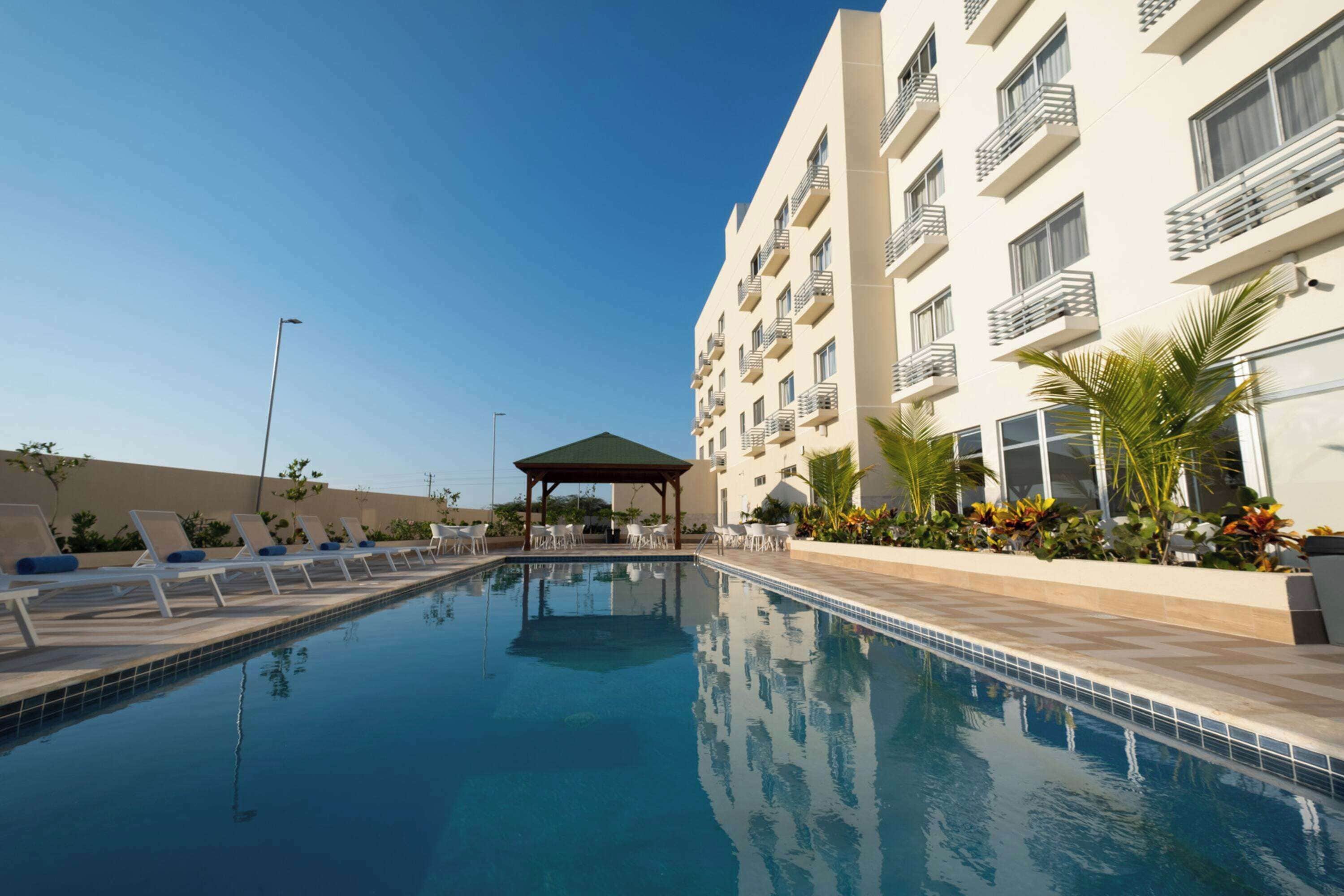 Outdoor pool, open 10:00 AM to 6:00 PM, pool umbrellas, pool loungers