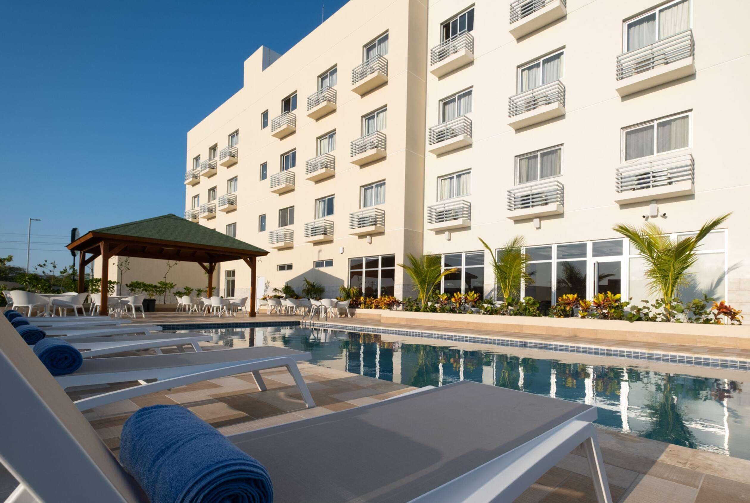 Outdoor pool, open 10:00 AM to 6:00 PM, pool umbrellas, pool loungers