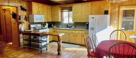 Full-size fridge, cookware/dishes/utensils, spices