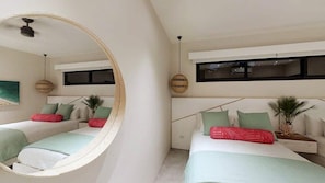 A bedroom with two beds, a large mirror, and a ceiling fan.