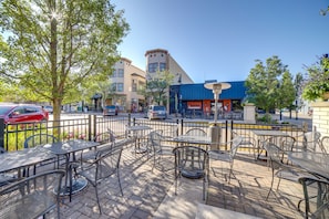 Relax in the serene outdoor patio area with a brick-paved floor and comfortable seating.