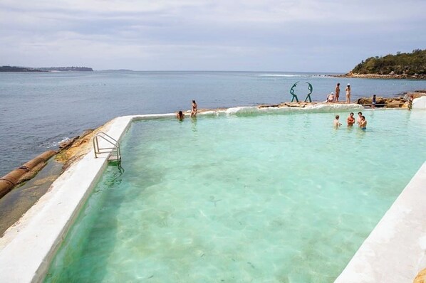 Guests can enjoy a refreshing swim in this pool overlooking the ocean.