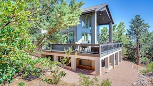 A modern two-story house with a balcony, surrounded by trees and gravel. - Hot Tub + Deck: Mtn-View Pine Getaway! (Pine)