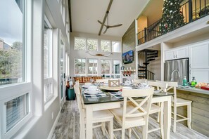 A spacious kitchen with a dining area, large windows, and a Christmas tree. - Hot Tub + Deck: Mtn-View Pine Getaway! (Pine)