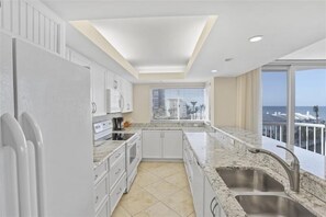 Enjoy ocean views from the kitchen window, featuring an oven, sink, and ample counter space.