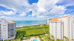A resort with a pool, beachfront view, and multiple buildings. - 3 bedroom 12th floor beachfront condo - CL1204 (Naples)