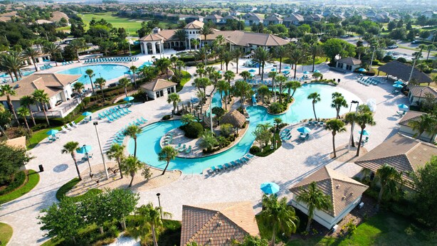 An aerial view of a resort with multiple swimming pools, palm trees, and lounge areas. - Family Getaway near Disney, Private Pool, Theater, Game Room & Themed Bedrooms (Davenport)