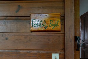 A wooden wall with a sign that reads "Poltilly Bight".