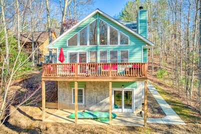 Cozy home with wraparound deck, fireplace, AC, & W/D