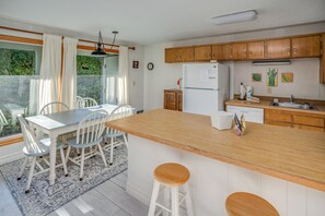 Enjoy cooking in this well-lit kitchen with a central island, sink, and ample storage.