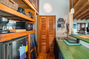 Fridge, microwave, coffee/tea maker, cookware/dishes/utensils