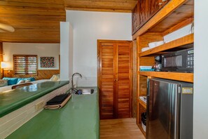 Fridge, microwave, coffee/tea maker, cookware/dishes/utensils