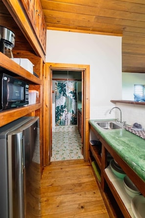 Fridge, microwave, coffee/tea maker, cookware/dishes/utensils