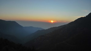 A mountainous landscape with a sunset. - Hidden Valley Camp (Nainital)