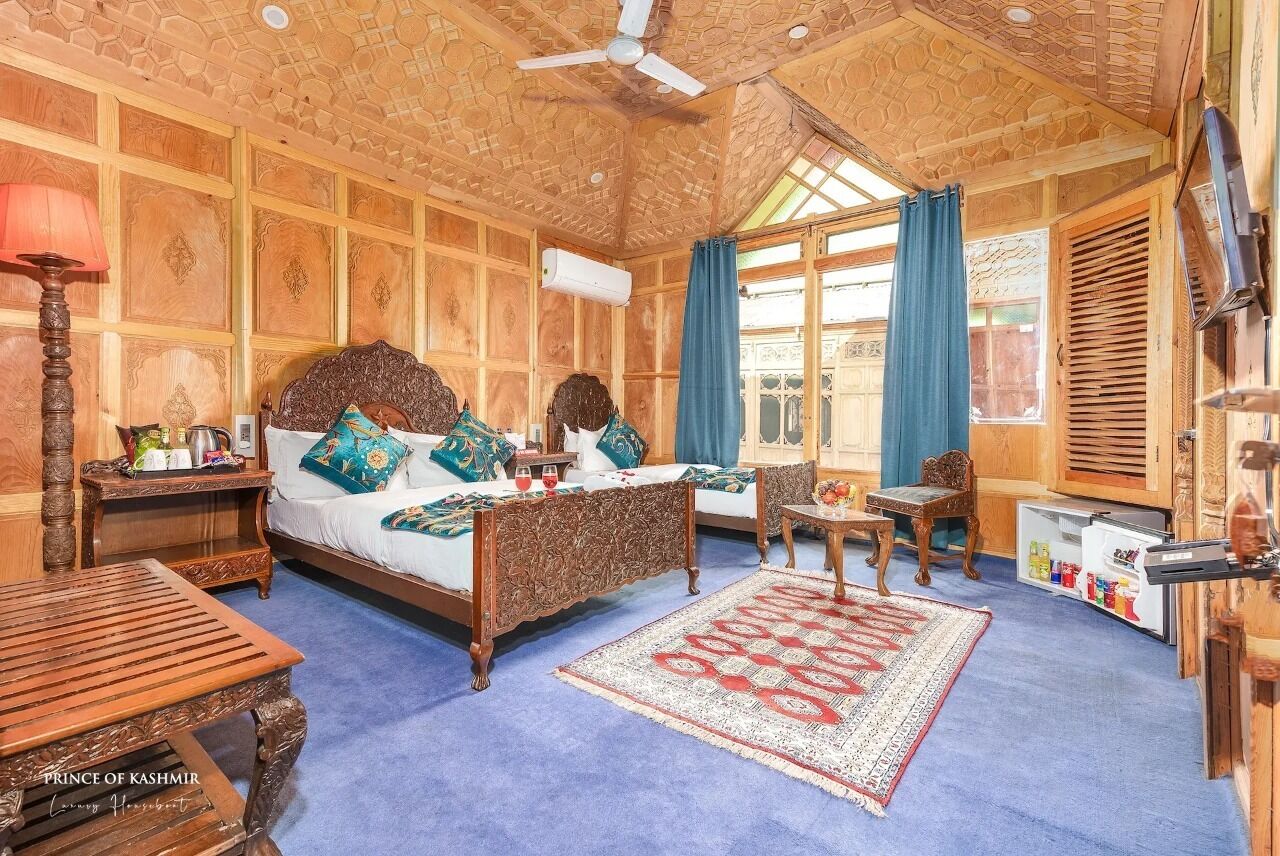 A traditional wooden room with a bed, a small table, and a chair.