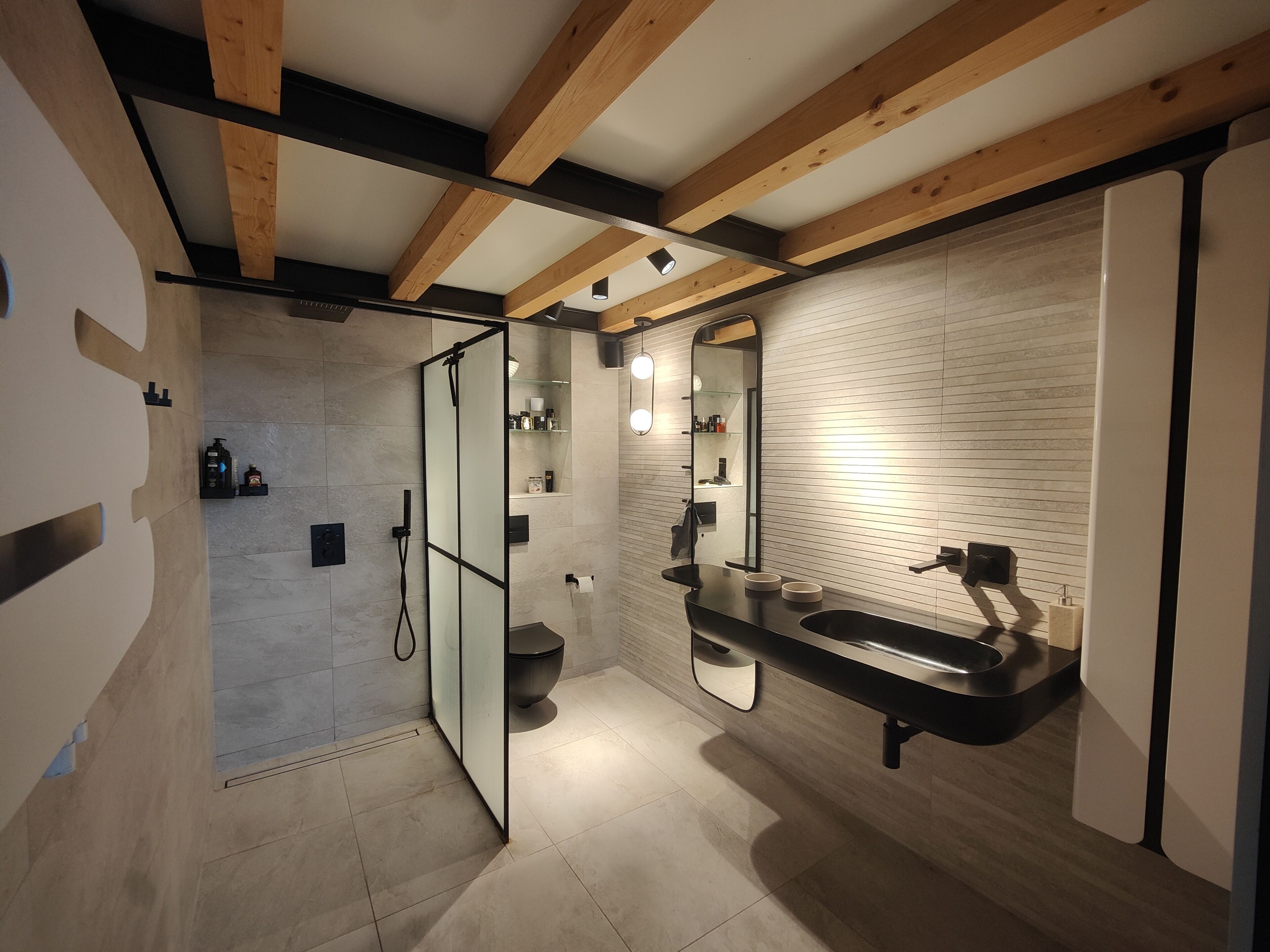 Une salle de bain moderne équipée d’une douche, de toilettes et d’un lavabo.