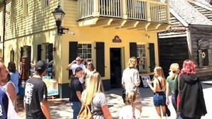 A yellow building with a balcony and a sign that reads "The Old Mill." - Historic St. Augustine Balcony Suite with Parking (Saint Augustine)
