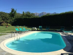 Una piscina con vistas despejadas a montañas al fondo.