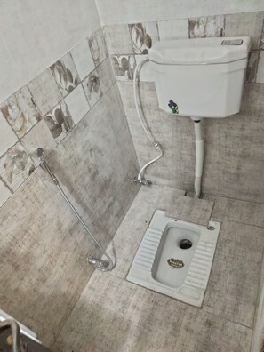 A bathroom with a toilet, a shower, and a bidet. - Inviting 3-bed House in Jhelum (Jhelum)