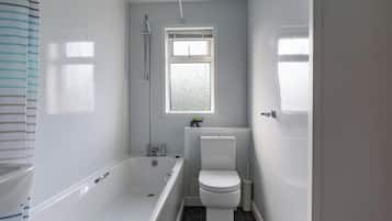 Combined shower/bathtub, deep-soaking bathtub, hair dryer, towels