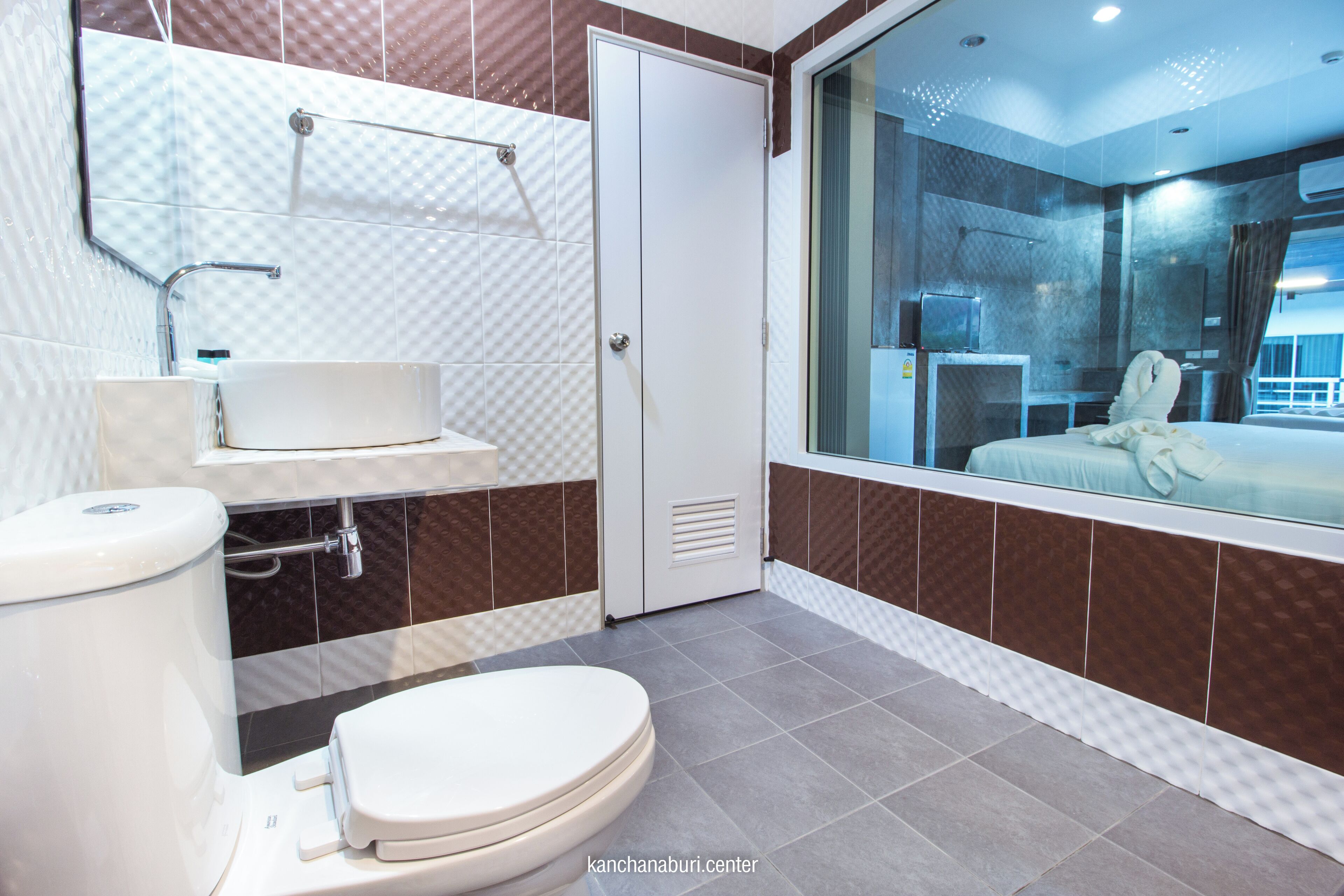 A modern bathroom with a toilet, sink, and shower area.