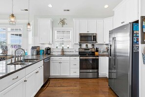 Fridge, microwave, oven, dishwasher - Experience coastal bliss at Sea You Soon, a spacious 4-bedroom retreat in Holden Beach, NC! (Holden Beach)