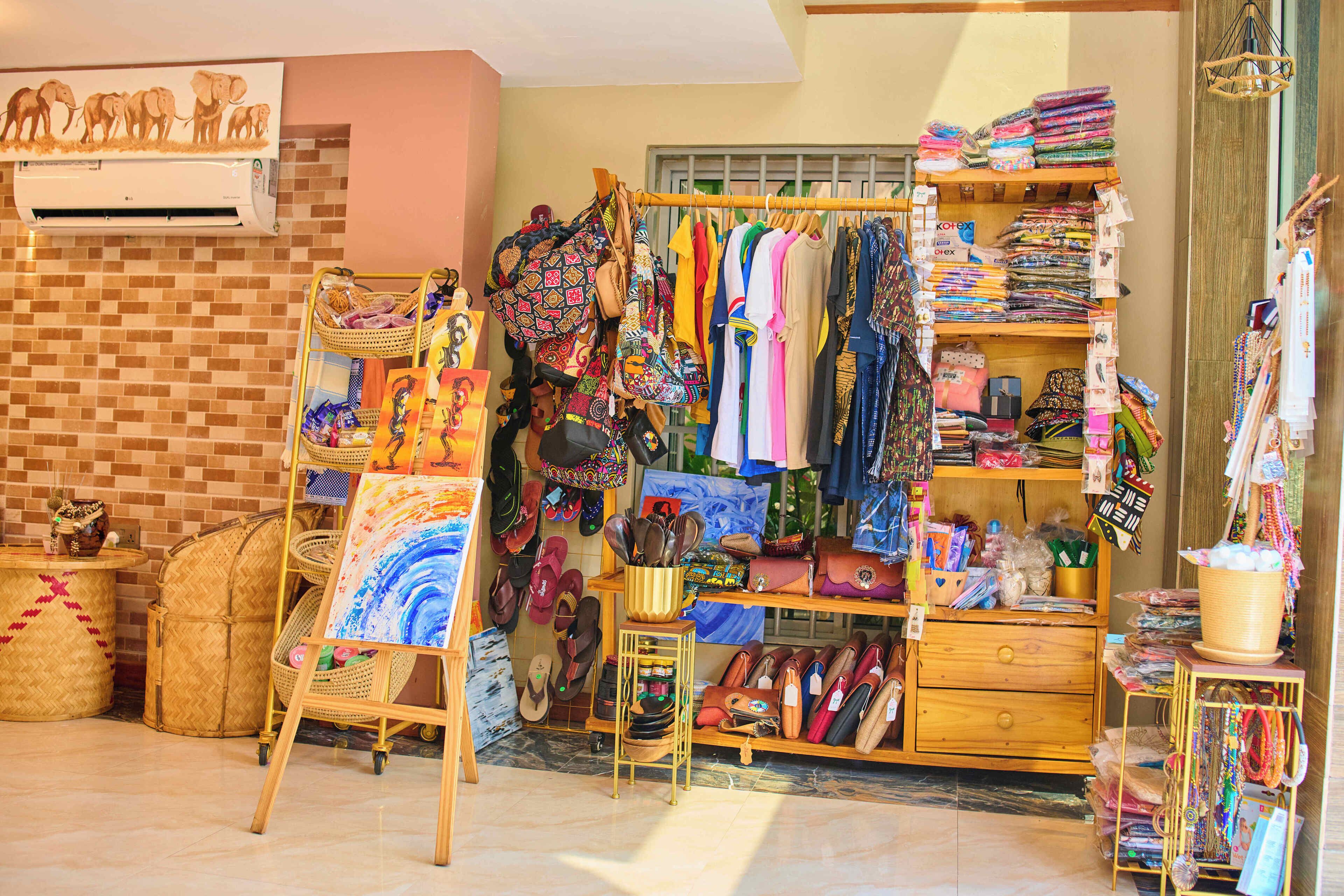 A boutique with a variety of colorful clothing and accessories displayed on shelves and racks.