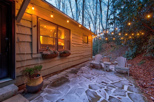Warm string lights and a stone patio welcome you home at Orchid Cabin. Perfect for a quiet evening in the Blue Ridge woods.
