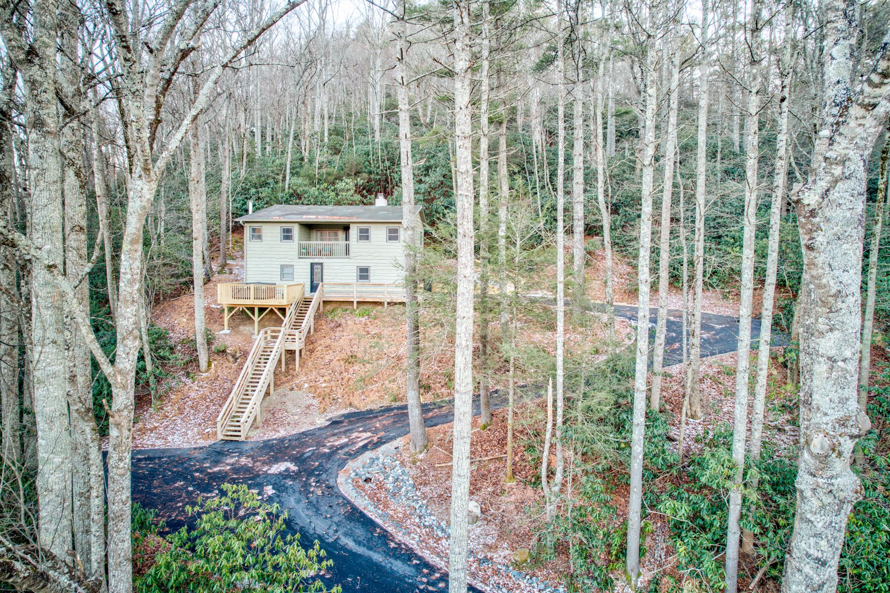 Tucked into the Blue Ridge woods, Orchid Cabin sits on a hillside with a raised deck and easy paved access for the whole group.