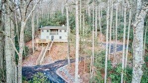 Eine Holzhütte mit einer Holzterrasse und einer Treppe, die zu einer Tür führt.