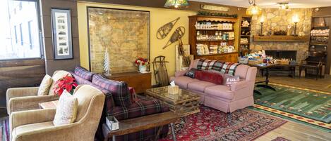 A cozy living room with a fireplace, a coffee table, and a sofa.