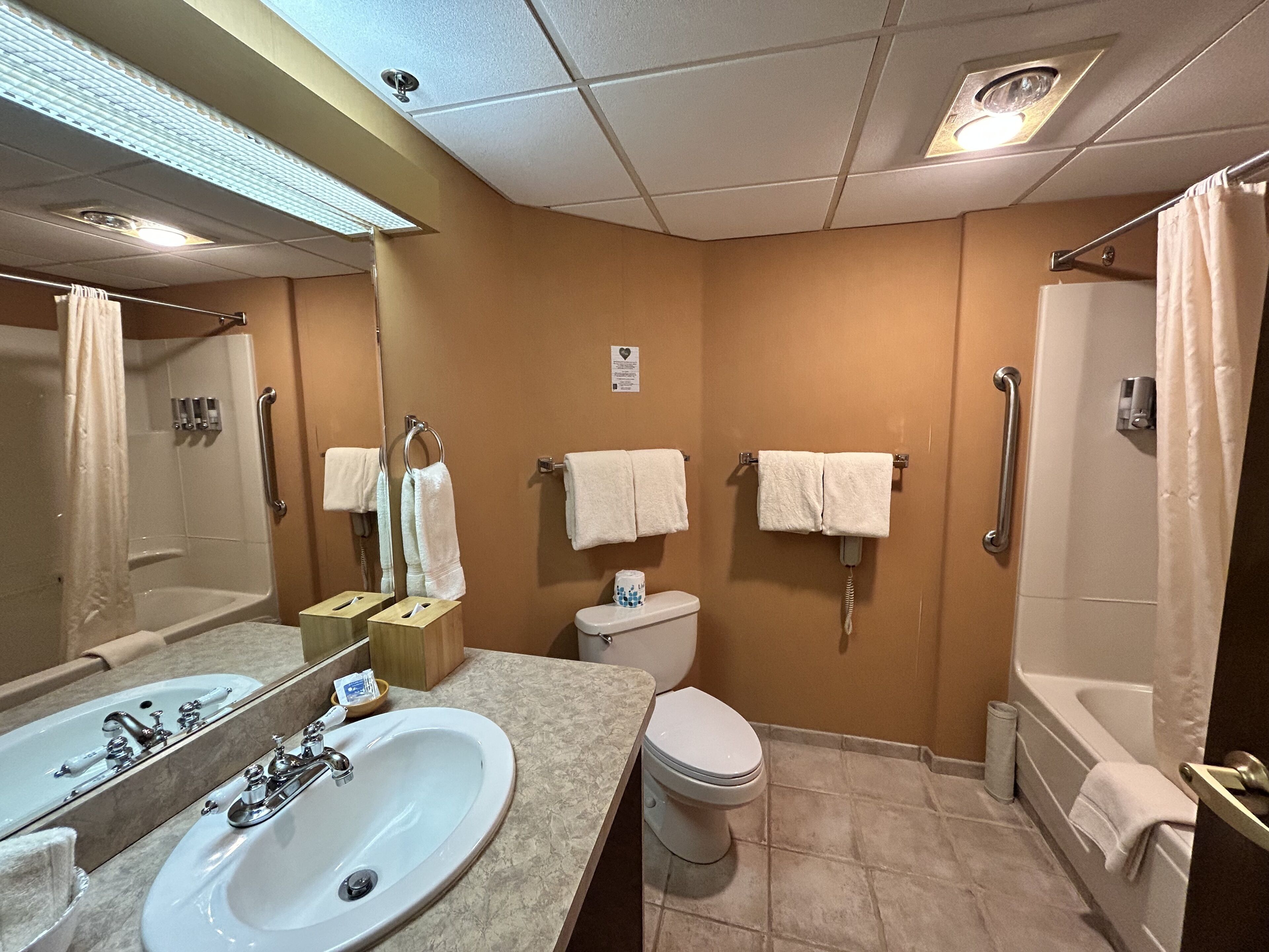 A bathroom with a sink, toilet, and shower.