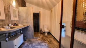 A bathroom with a sink, mirror, toilet, and tiled walls. - Village house with private pool, Grignan – Drôme Provençale (Grignan)