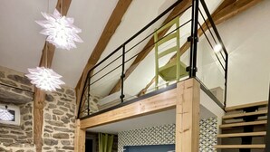 A bunk bed room with a stone wall, a wooden ceiling, and a green curtain. - Superb 450 m2 farmhouse fully restored in Haute Loire (Araules)